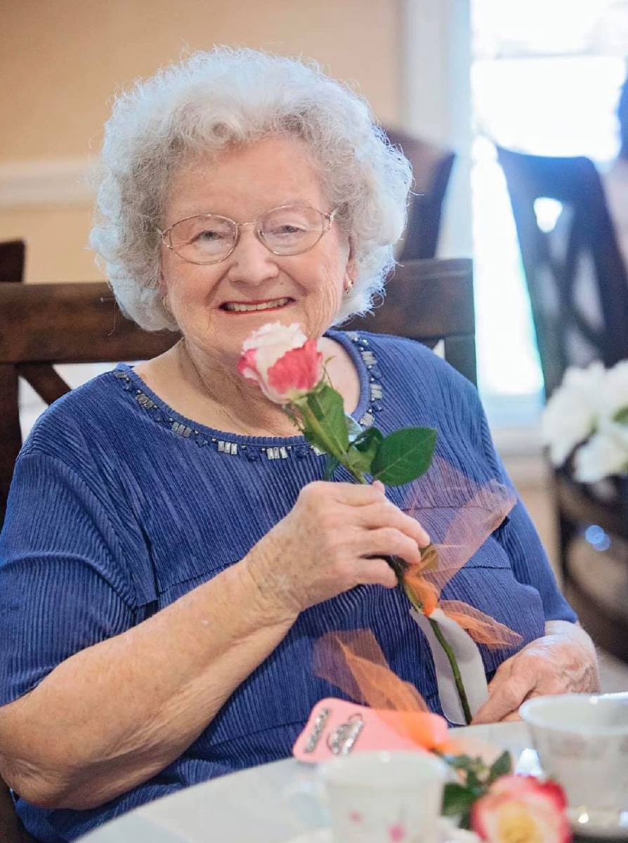 Baldwin House Resident Holding a Rose